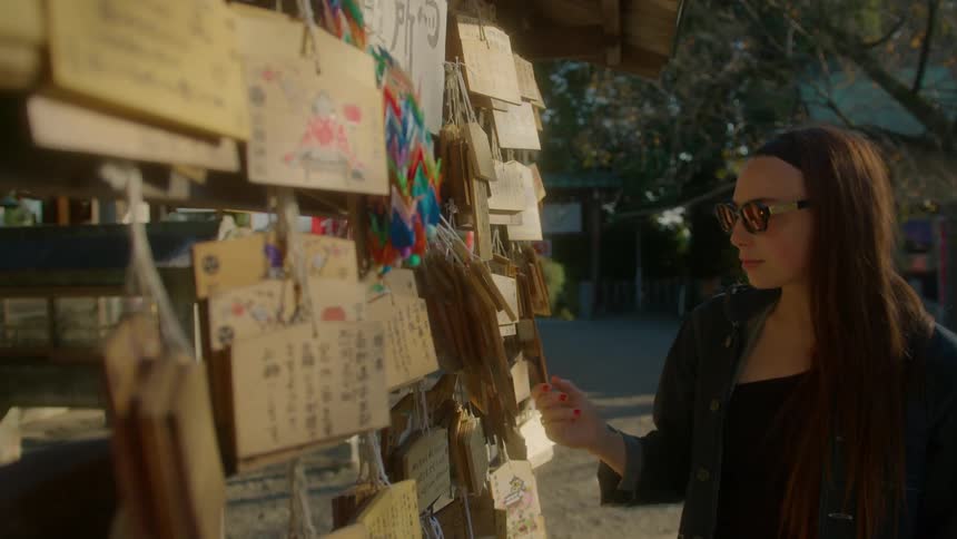 A woman looks at messages written on pieces of paper