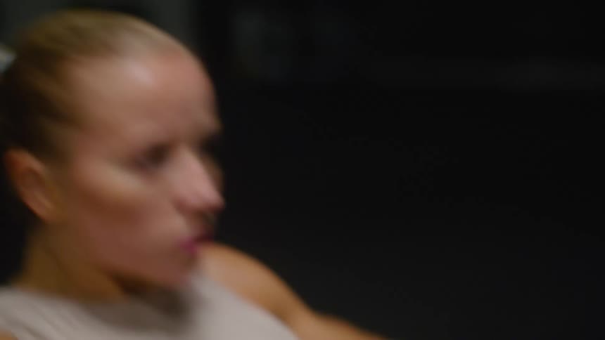 Woman with a ponytail works out in the gym