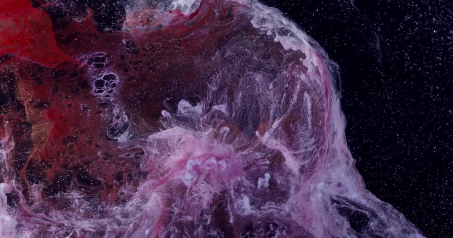 A fluid has other colors like pink and red mixed into it as it flows