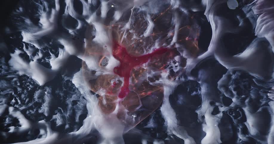 An abstract object that is expanding in a smoky shape and in the center a red color
