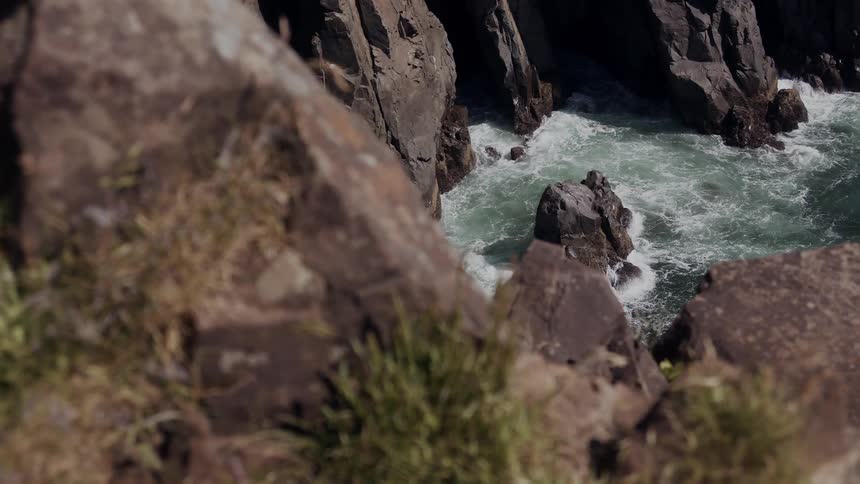 Tidal waves smash into a rocky coastline