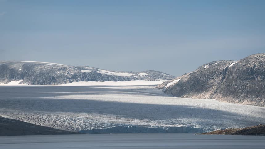 Arctic landscape with sea and clouds passing by in timelapse