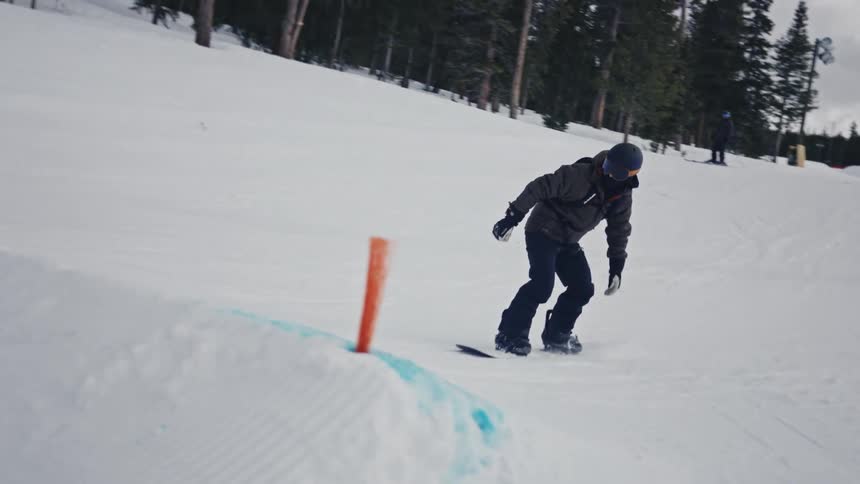 A man skied over a pile of snow during the day