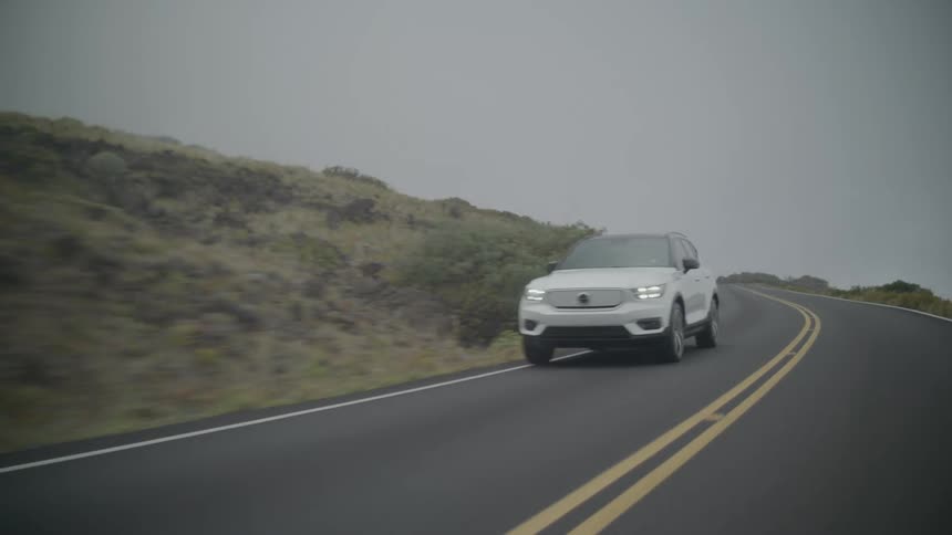 A motor vehicle moving fast on a freeway at dawn