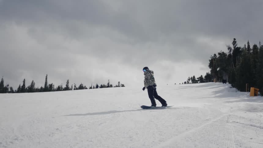 Person skiing on a gentle slope on a snowcovered mountain on a cloudy day