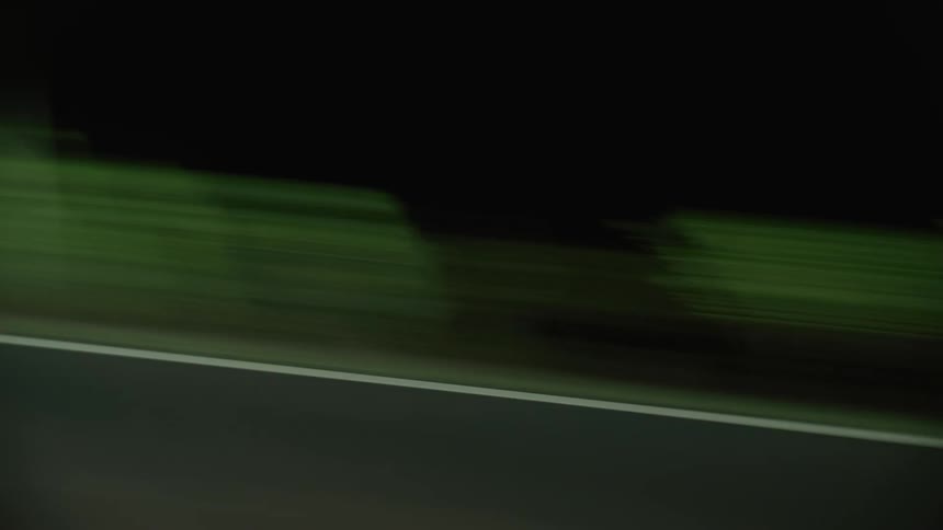 Point of view of a reflection of a light from a vehicle in the middle of the road at night
