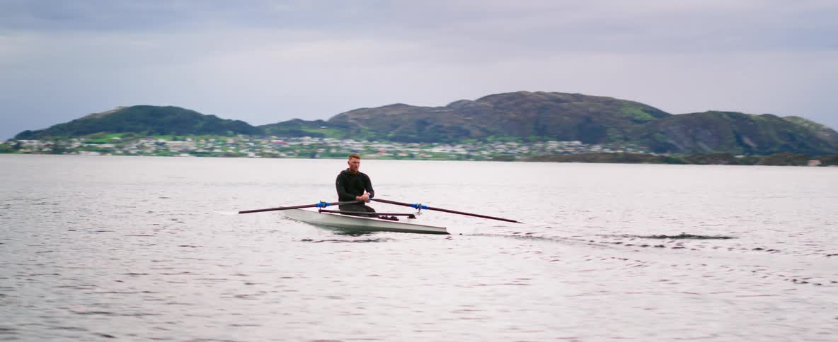 An isolated and focused man is pushing the limits by training on a vast expanse of water