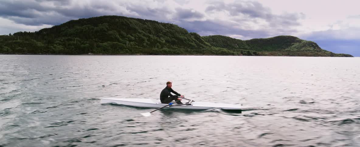 An Olympic rower stays focused on the scenic open water in Norway's fjords
