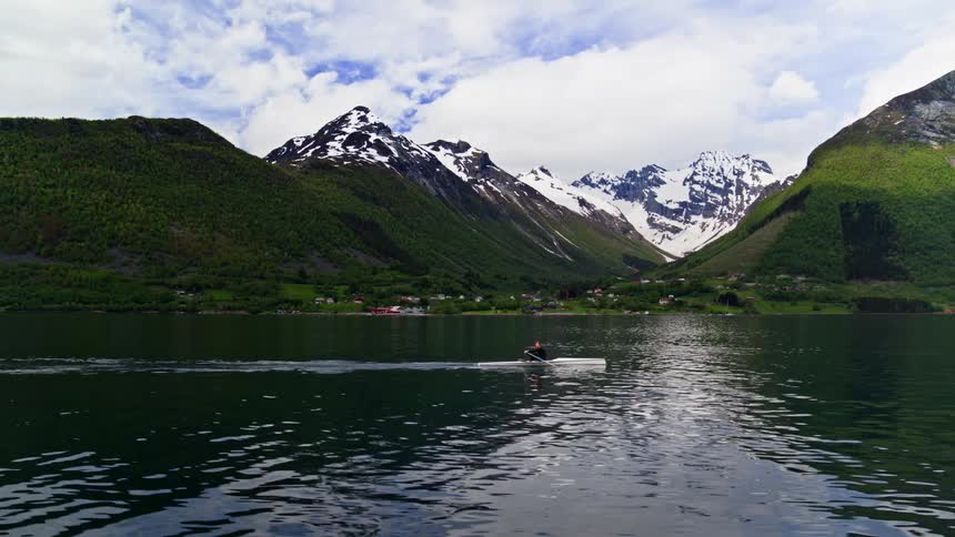 Person rowing a boat on the river during the day