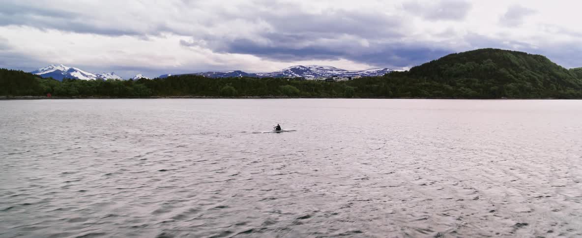 Person rowing a boat on the sea during the day