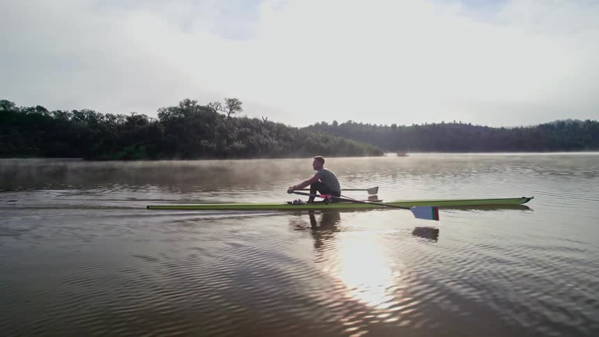 Olympian trains on the water in the early morning showing his dedication and daily routine