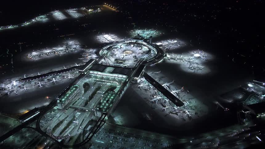 Aerial view of a large airport hub at night