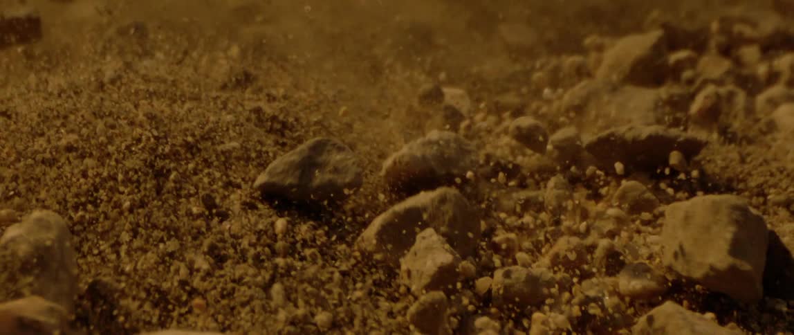 Closeup on shaking desert ground and bouncing rocks