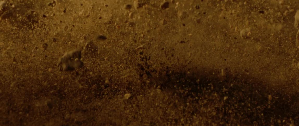 Desert ground shaking causing sand and rocks to bounce