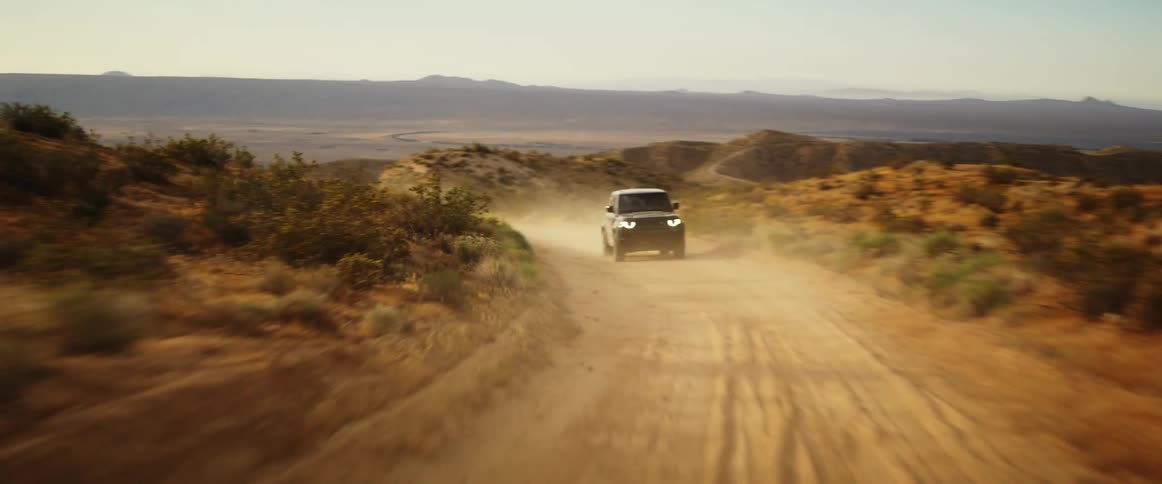 A truck driving in a lonely road in the valley at dawn