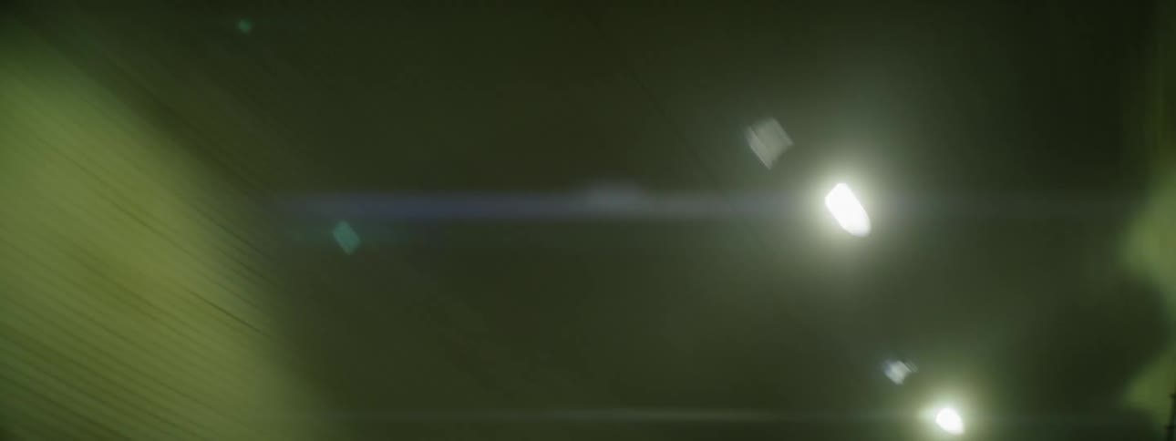 Lights are on the ceiling of the long dark tunnel