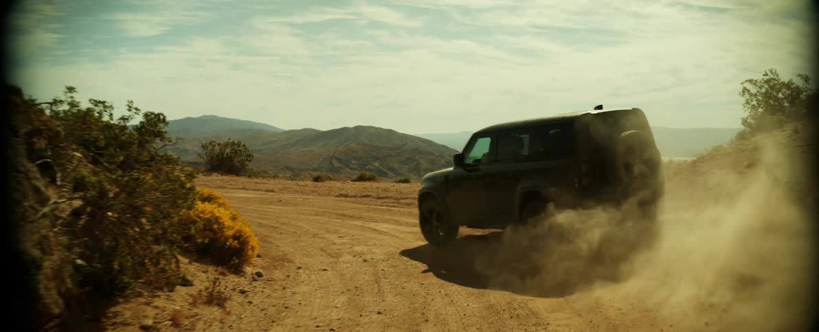 A vehicle making a turn on a desert road