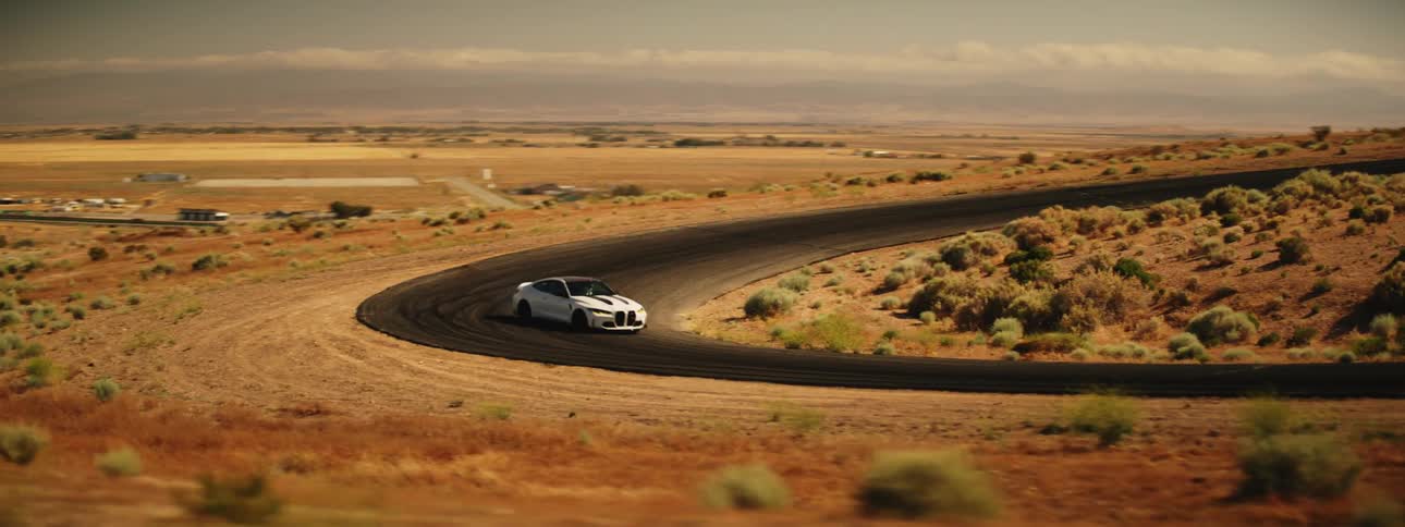 White bmw coup drifting on a road in a natural environment