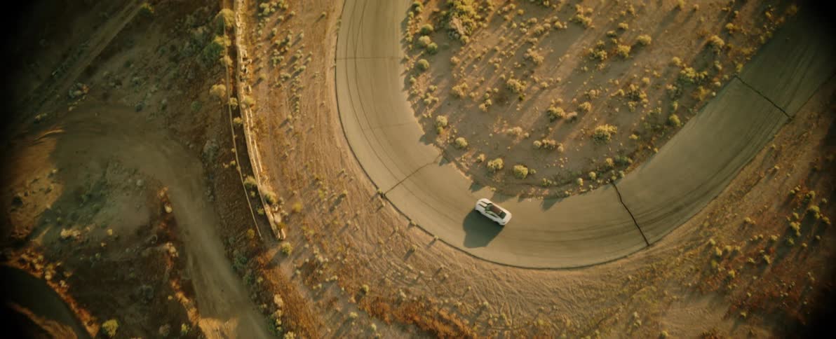A car leaves a dust cloud as he speeds away