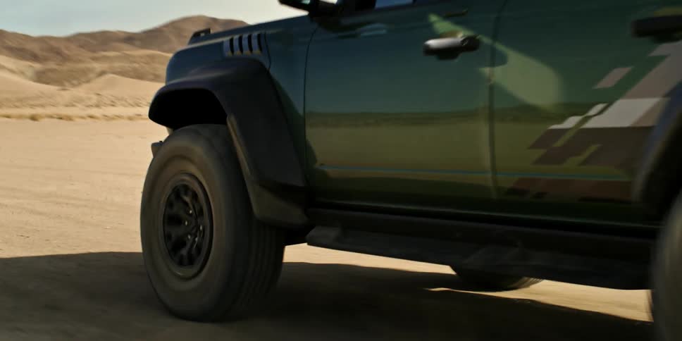 Jeep in motion on a dirt road in the desert