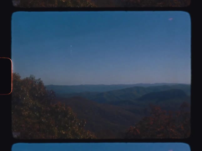 Landscape of mountains and forests in a cloudless blue sky