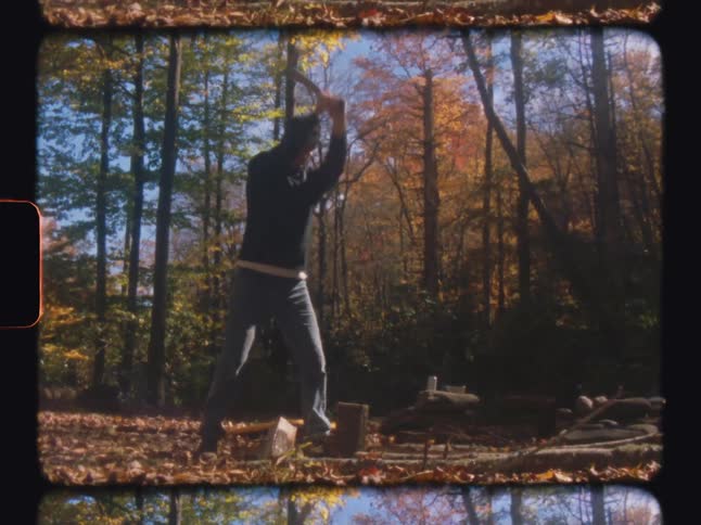 Man in a forest with an ax cutting a wooden stump and generating firewood