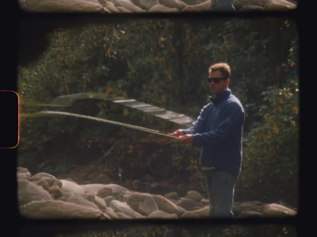 Man casting a fishing rod in long find in the forest