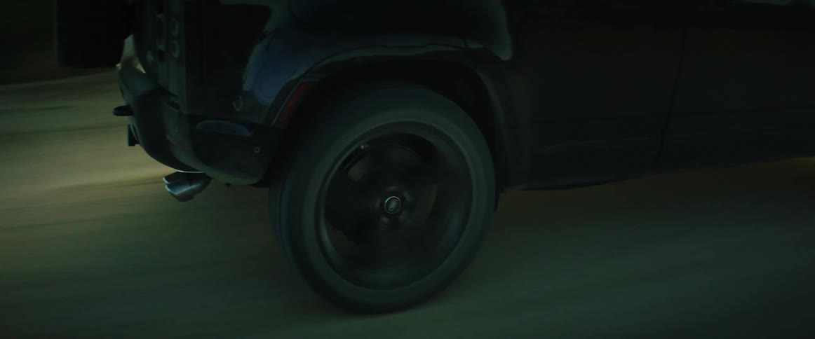 Closeup of a cars wheels on a dirt road