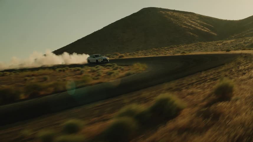 White bmw coup drifting on a mountain road