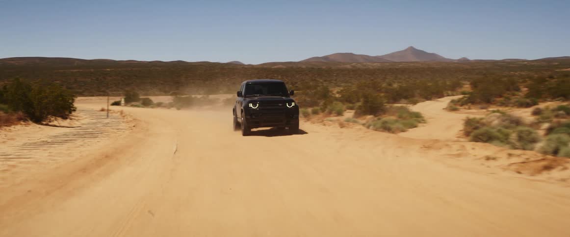 An suv driving on a dirt road in the valley