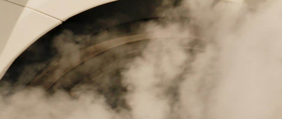 Closeup on a bmw alloy wheel accelerating and generating traction with smoke