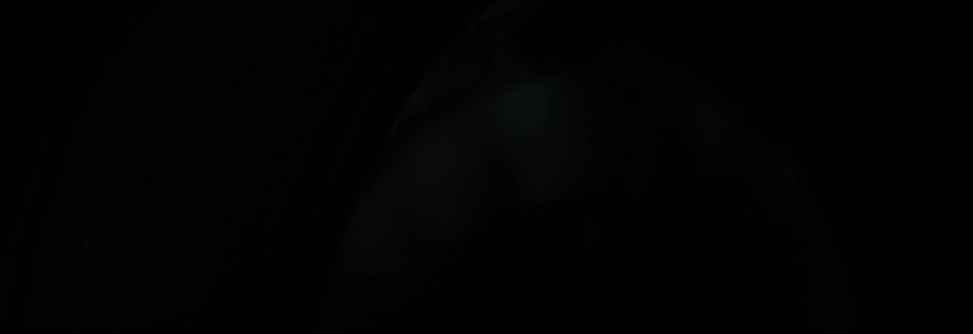 Closeup on an alloy wheel of a moving vehicle at night