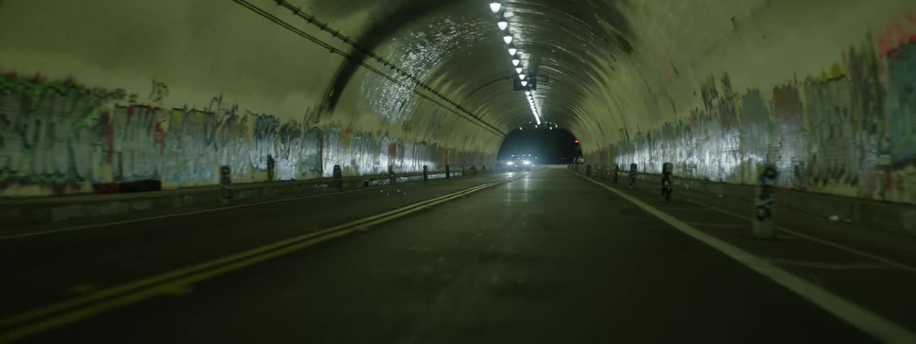 Vehicle passing at high speed through a tunnel in the city at night