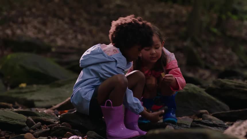 Two girls play in a stream