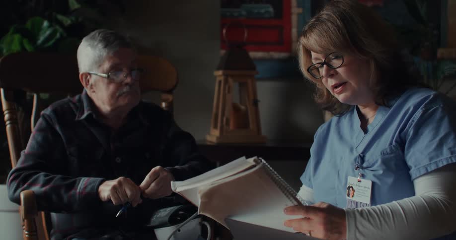 A nurse speaks to an elderly patient