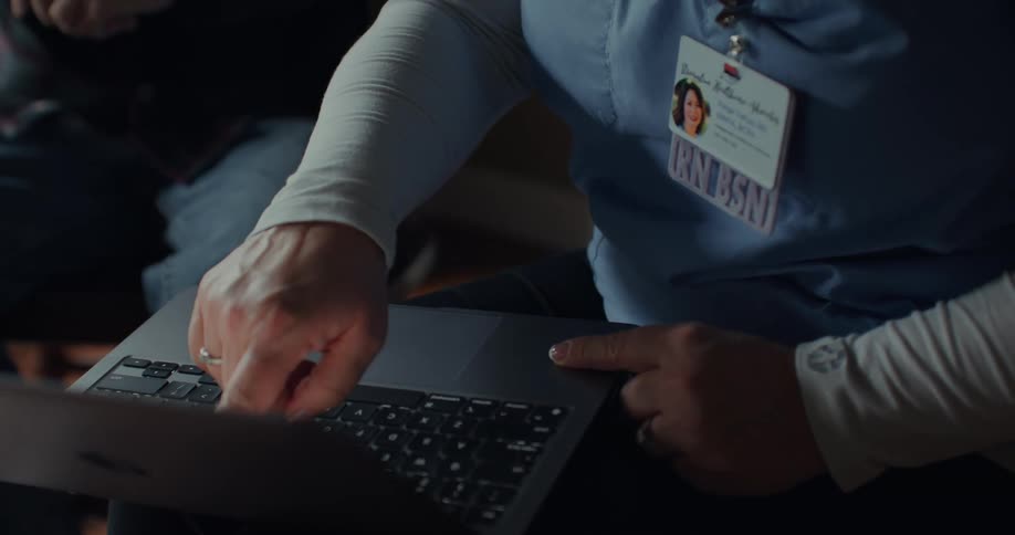 A nurse uses a laptop