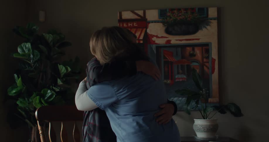 A nurse and a patient hug