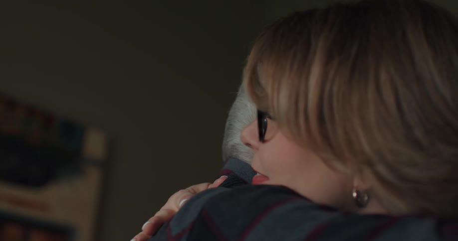A nurse hugs her male patient