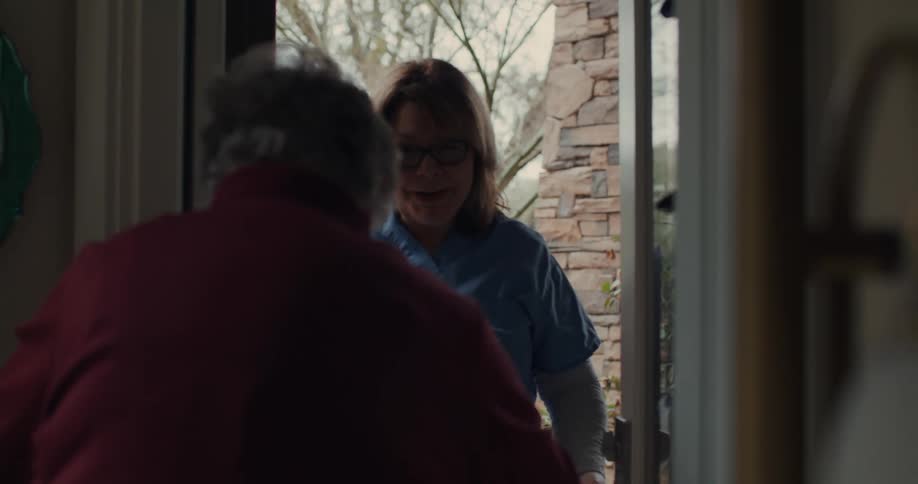 A clip of a nurse entering into a patients house