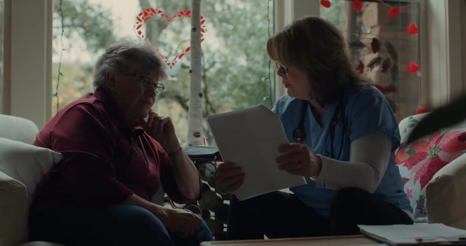 A clip of a nurse reading a document to an elderly lady