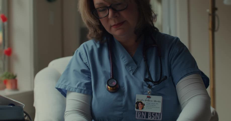 A nurse collects blood from a patients finger