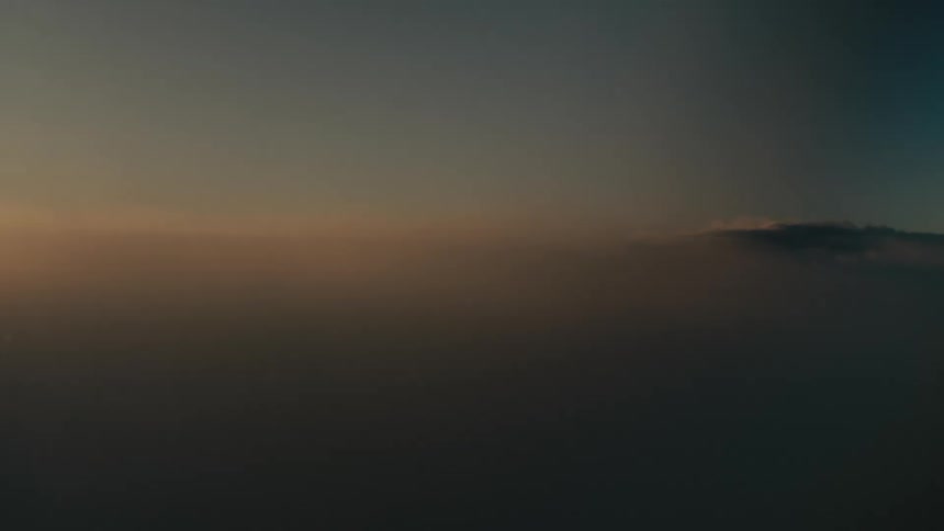 A closeup of clouds illuminated by a soft glow of sunlight