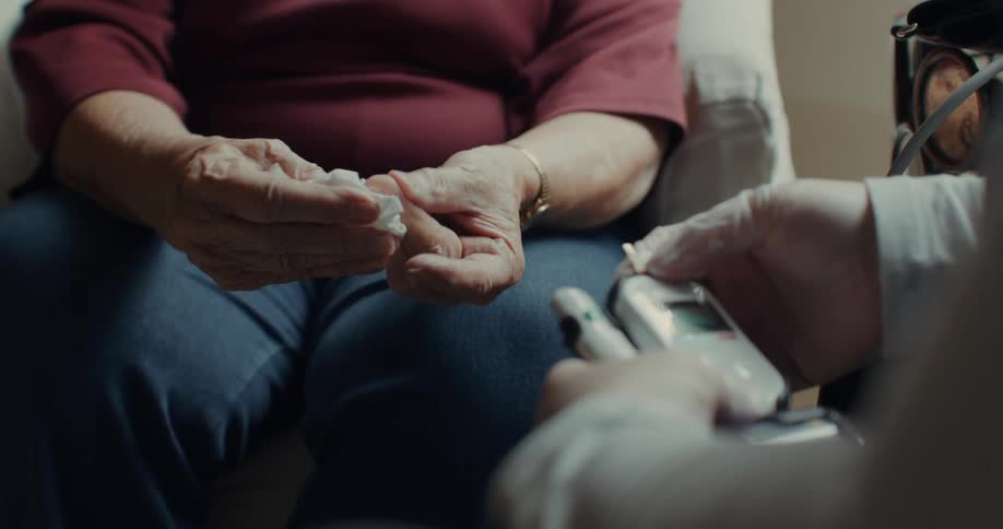 A healthcare professional checks a patients blood sugar levels