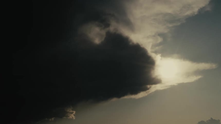 Dark clouds moving to block the sunlight on an otherwise clear day