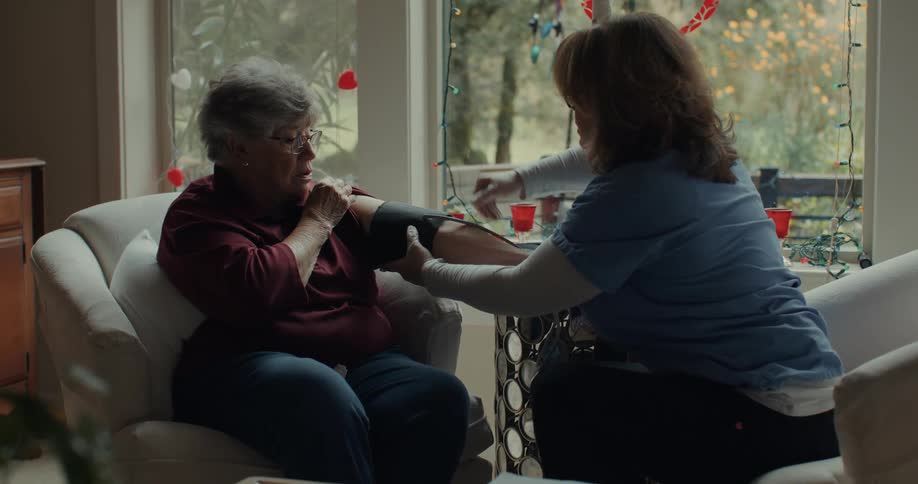 A clip of a nurse checking the blood pressure of an elderly patient