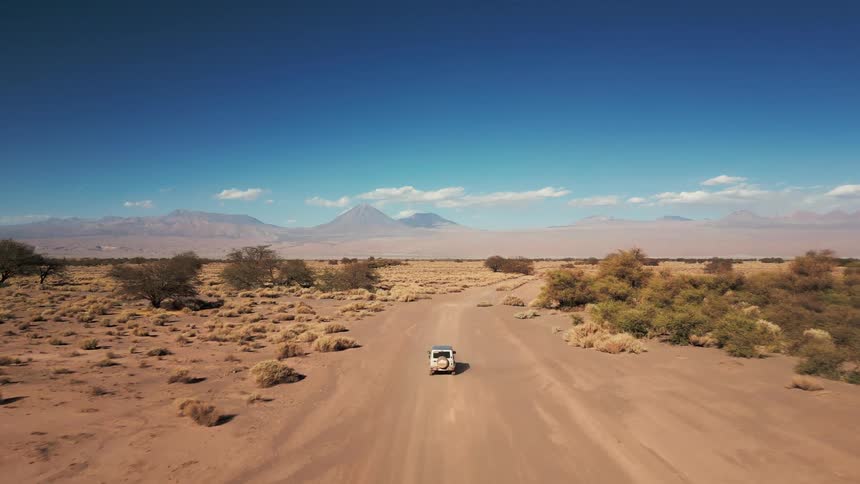 A truck is driving on the desert road