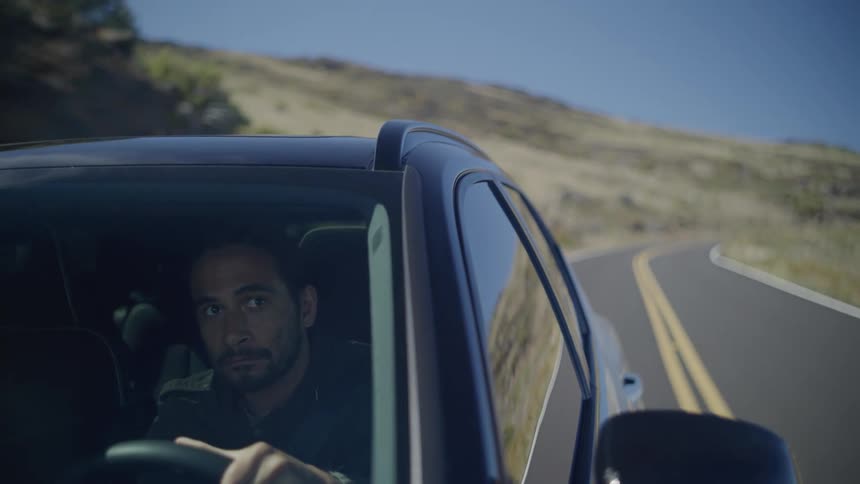 A clip of a man driving a car on a freeway