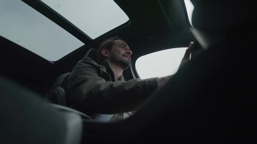 Close up of a man driving a sports car