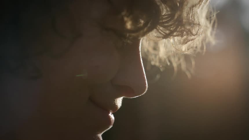A teenager breaks into a smile