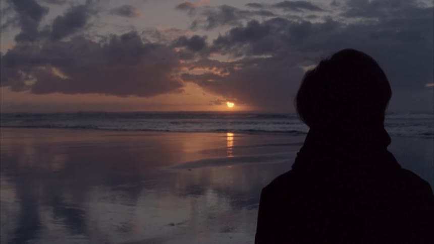 Someone watching a sunset over the sea